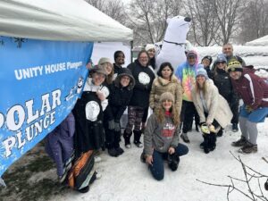 Unity House Polar Plungers team pose for a group photo outside of their tent at the event