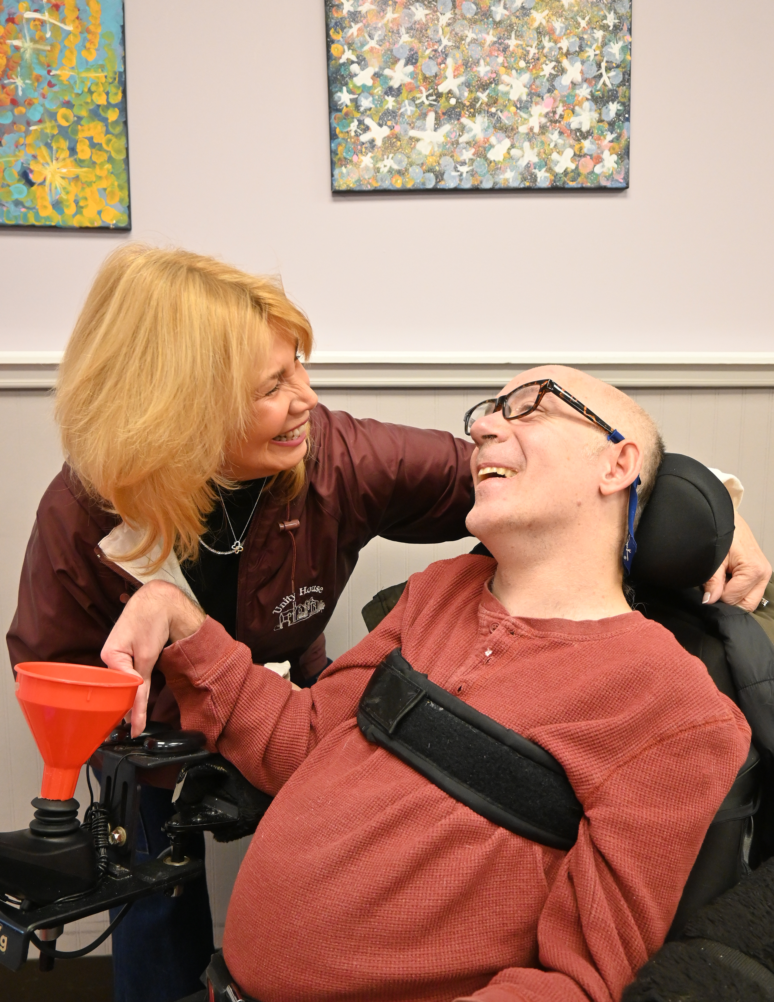 Unity House CEO Liz Smith greets Auburn Day Hab participant Rob Clark